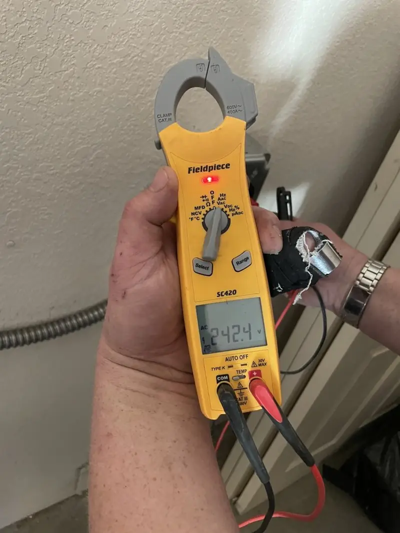 Voltage testing with clamp meter during Electrical Installation Services in Barberton